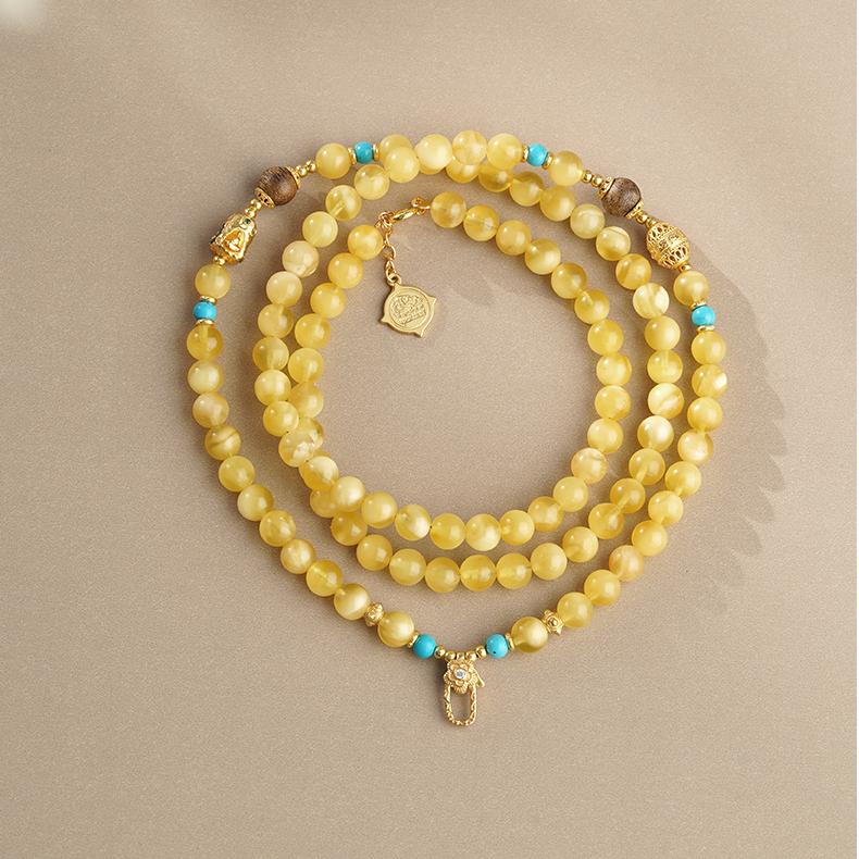 Detailed amber and agarwood necklace with 925 silver beads and Potala Palace-inspired design.