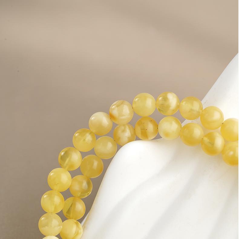 Tibetan amber and agarwood necklace representing calmness, wisdom, and enlightenment in Buddhist jewelry art.