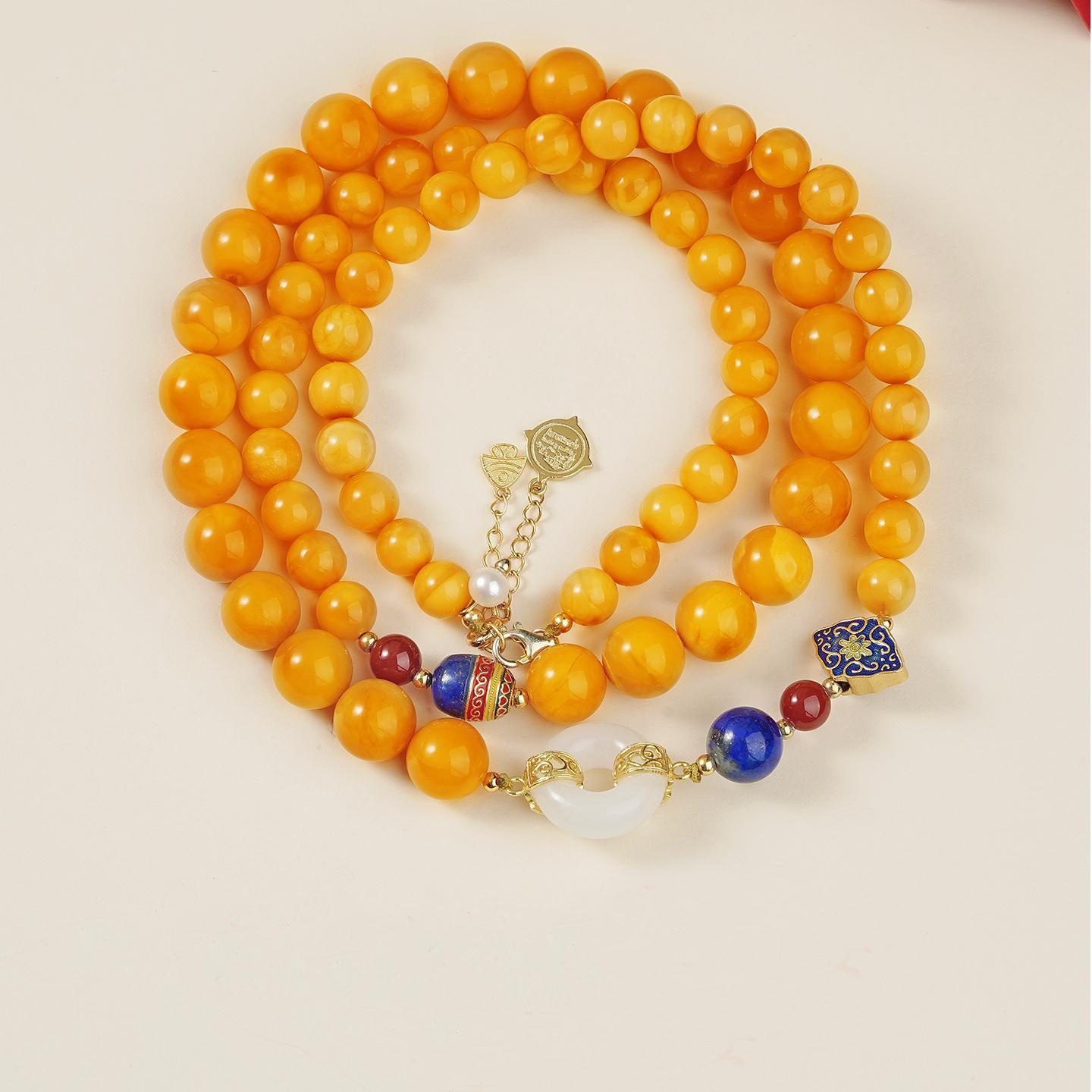 Handmade Tibetan Buddhist amber necklace featuring Hetian jade, lapis lazuli, pearls, and 925 silver for harmony and peace.