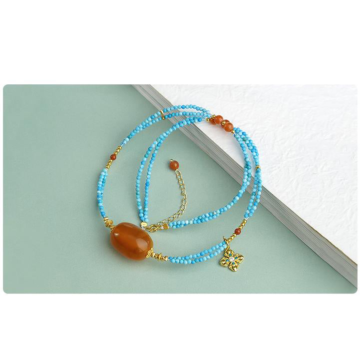 Tibetan silver and amber necklace bringing positive energy and spiritual protection.