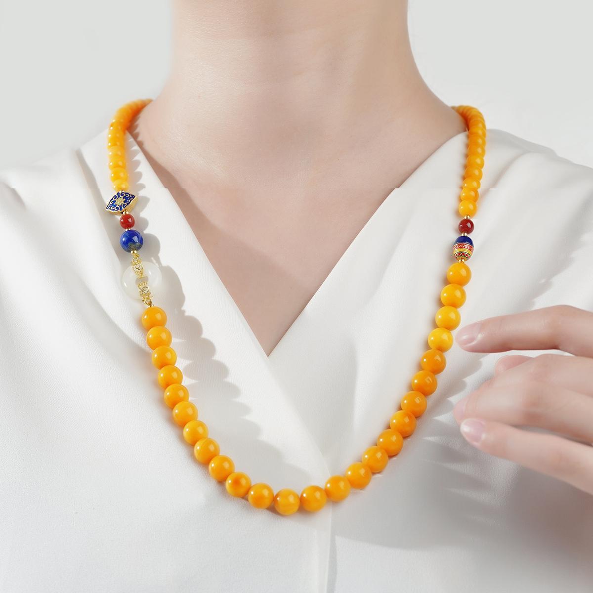 Tibetan Buddhist amber necklace combining Hetian jade and South Red Agate, handmade with sacred symbolism.