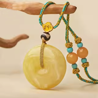 Artisan Tibetan amber pendant with tiger tooth Dzi bead, a symbol of balance and serenity
