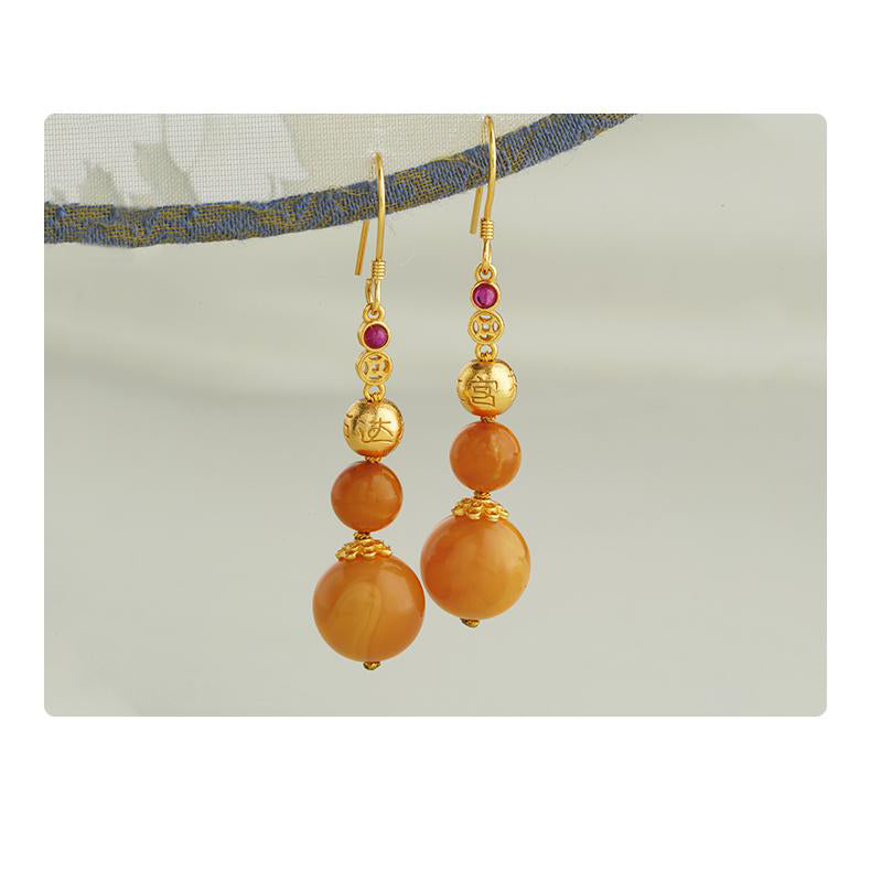"Tibetan Buddhist amber earrings with 925 silver, featuring a golden wind-dew design and zircon embellishments."