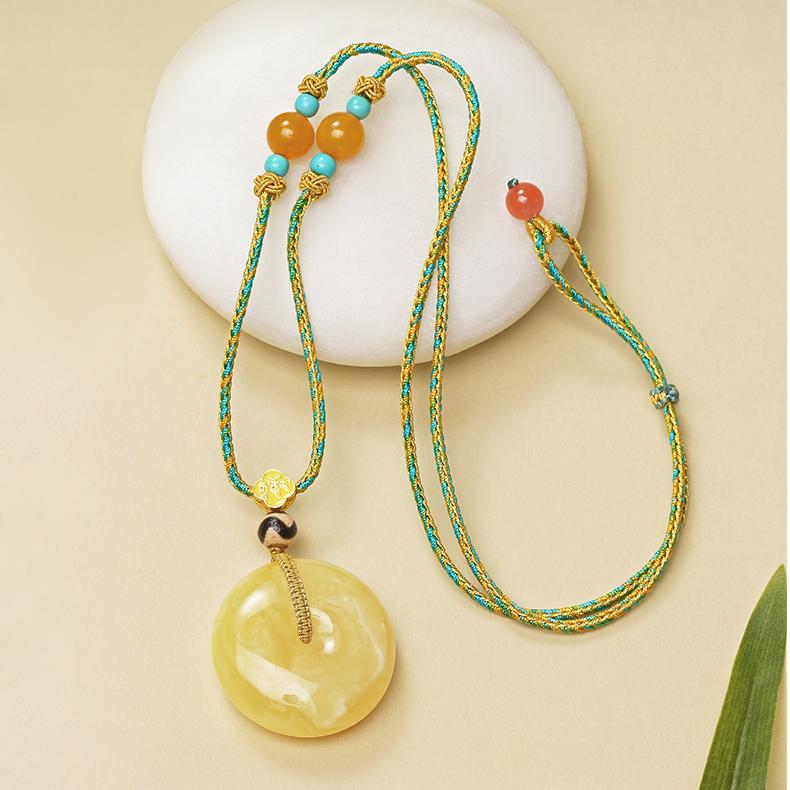 Tibetan Buddhist amber talisman pendant with tiger tooth Dzi bead, enhancing peace and prosperity