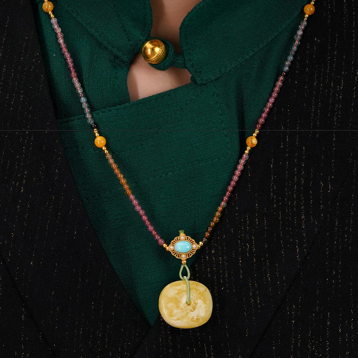 Tibetan Buddhist amber pendant crafted in silver, expressing beauty, calm, and protective energy.