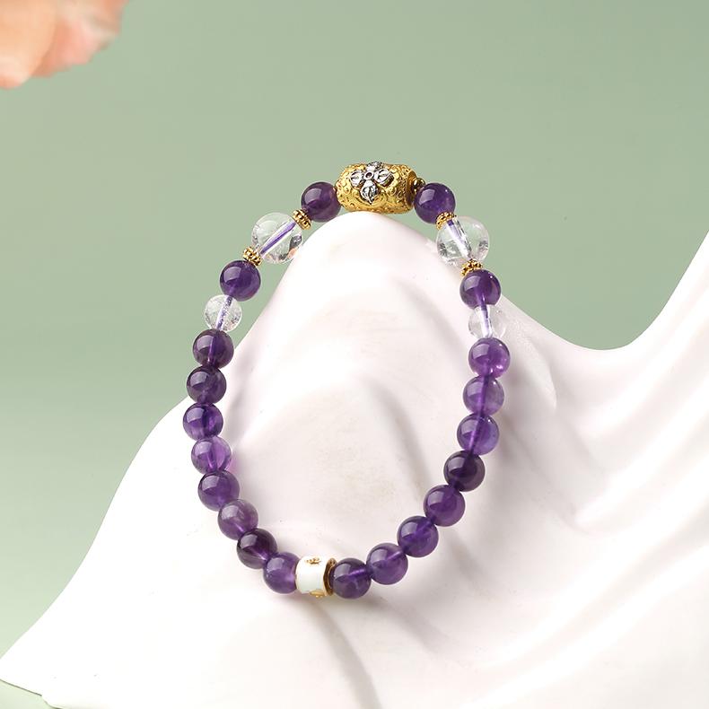 Tibetan-Buddhist handmade Amethyst and Clear Quartz bracelet with 6.5 mm and 8 mm beads, adjustable fit, featuring bronze spacer beads.