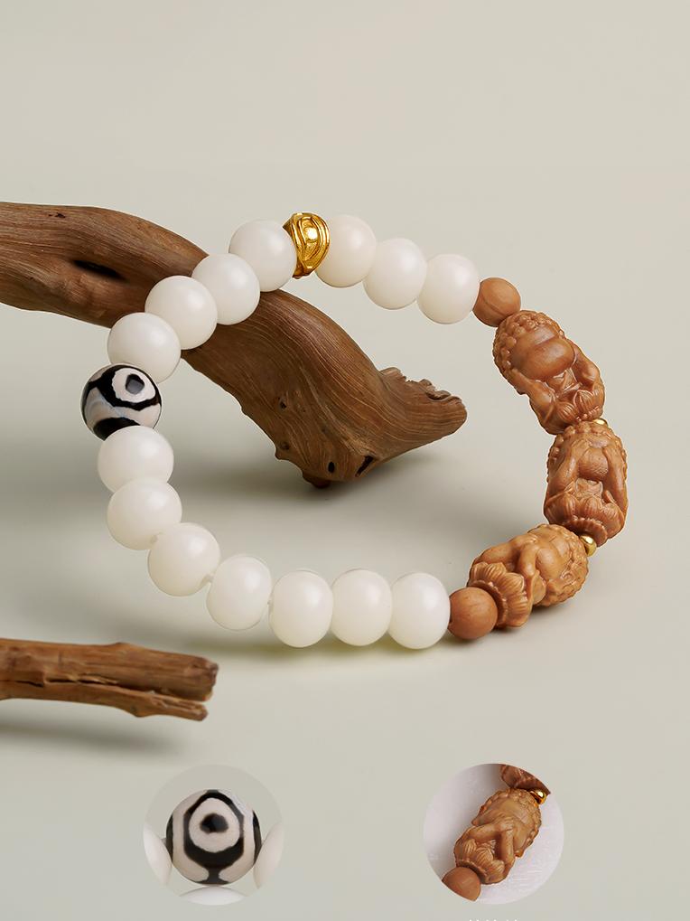 Tibetan-Buddhist Anru Bodhi bracelet featuring three-eye Dzi bead and silver Wisdom Eye charm, handcrafted spiritual jewelry