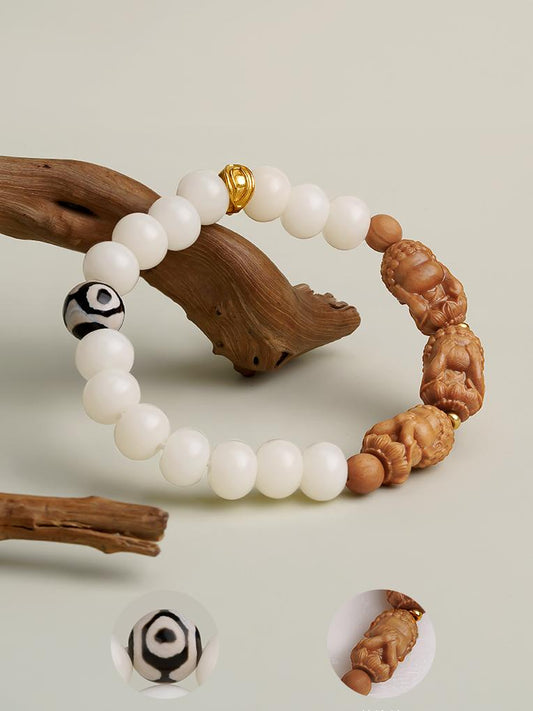Tibetan-Buddhist Anru Bodhi bracelet featuring three-eye Dzi bead and silver Wisdom Eye charm, handcrafted spiritual jewelry