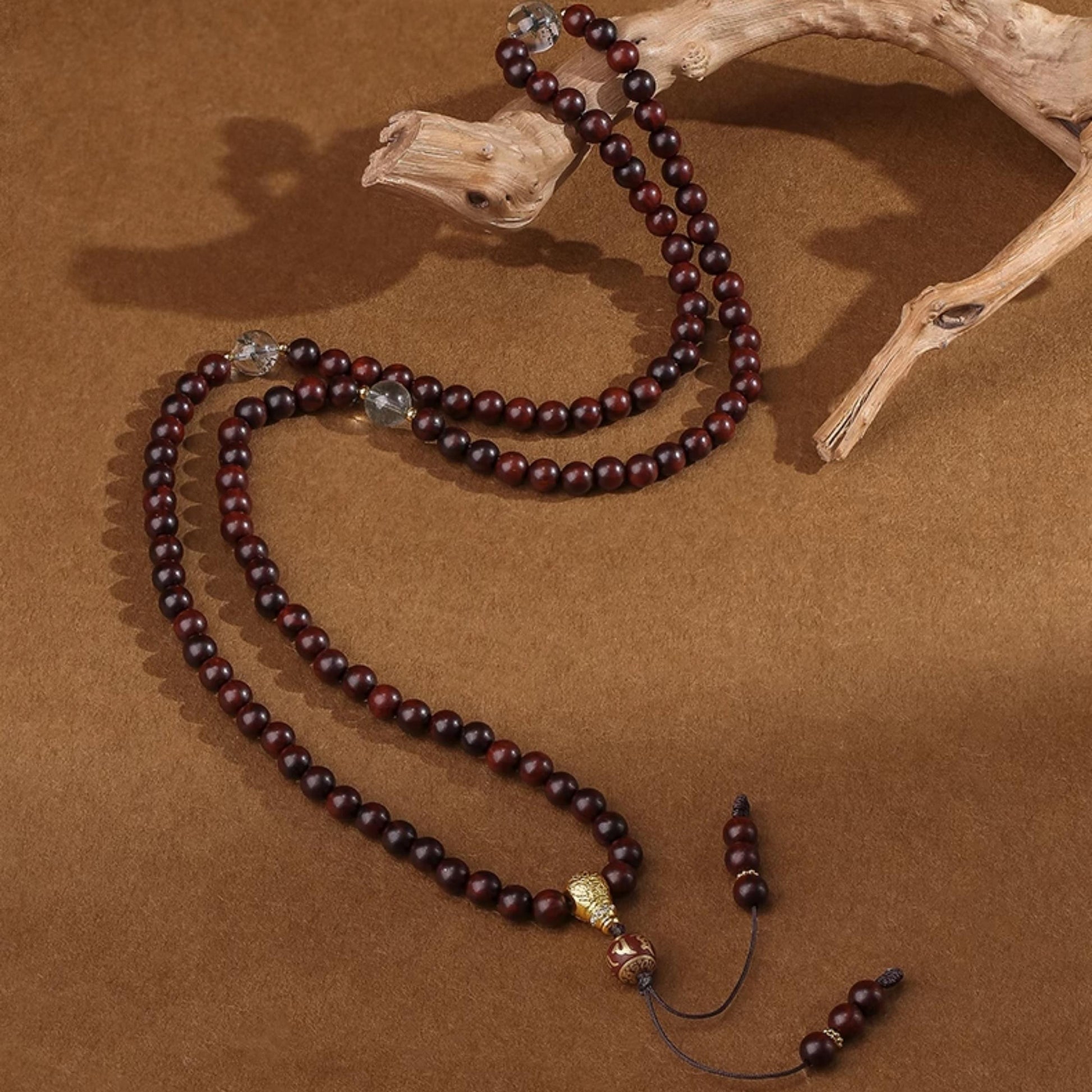 Tibetan Buddhist sandalwood mala with green phantom centerpiece and silver mantra bead detailing