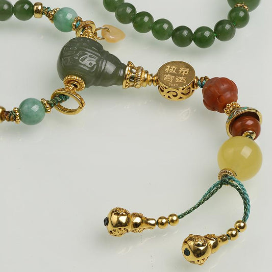 Artisan Tibetan Buddhist jewelry crafted with jade, jadeite, amber, and silver beads, symbolizing harmony and wisdom.