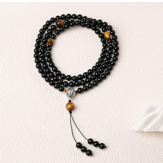 Handmade Tibetan Buddhist obsidian mala featuring tiger eye beads and a silver three way connector