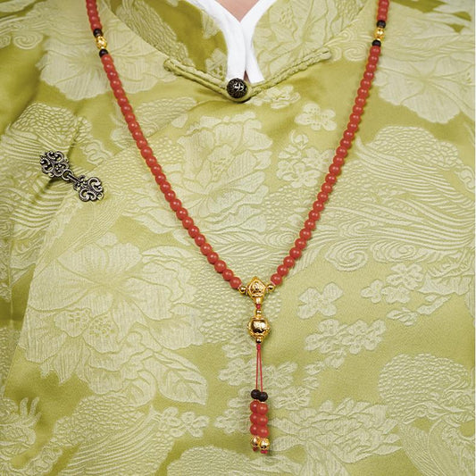 Tibetan Buddhist red agate mala with silver mantra beads for peace and protection.