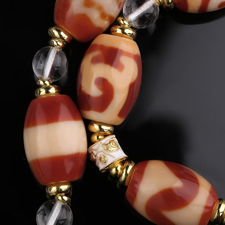 Handmade Tibetan necklace with red agate, white crystal, and copper accents, perfect for meditation and energy harmony.