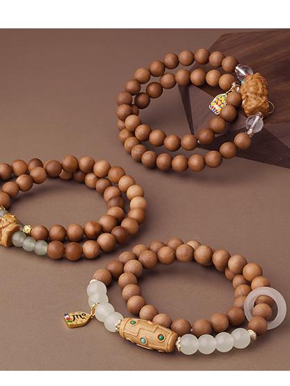 Tibetan-Buddhist sandalwood bracelet featuring the Five Wealth copper plaque and artistic pendant design.
