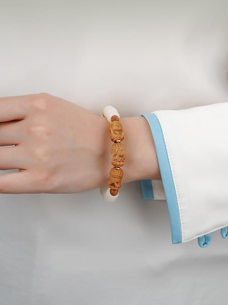 Tibetan-Buddhist Bodhi bracelet with three-eye Dzi bead, Barbie sandalwood charm, and silver spacers, handmade for meditation and peace