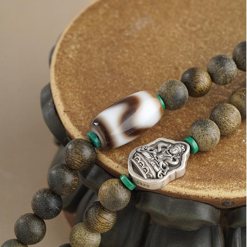 Tibetan handmade mala necklace with agarwood, red agate, and carved bone elements.