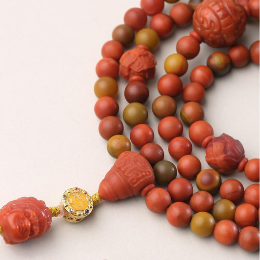 Tibetan Buddhist mala bracelet crafted with South Red Agate and silver details, symbolizing wisdom and vitality.