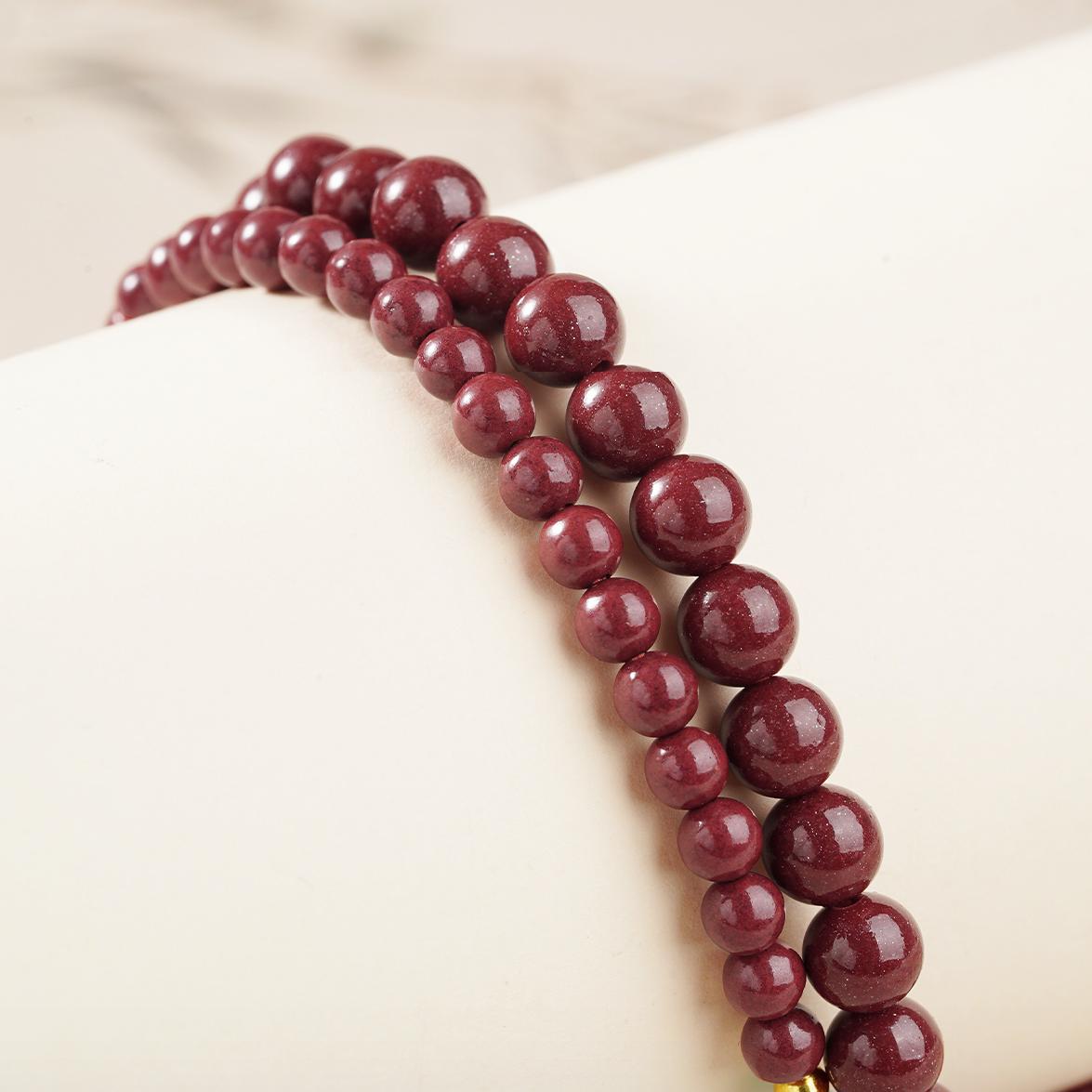 Tibetan Buddhist 108-bead cinnabar mala with amber and glass ornaments, spiritual necklace.