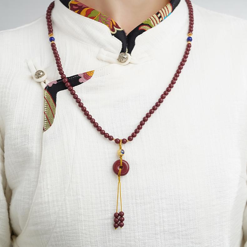 Handmade Tibetan Buddhist cinnabar mala with lapis lazuli accents
