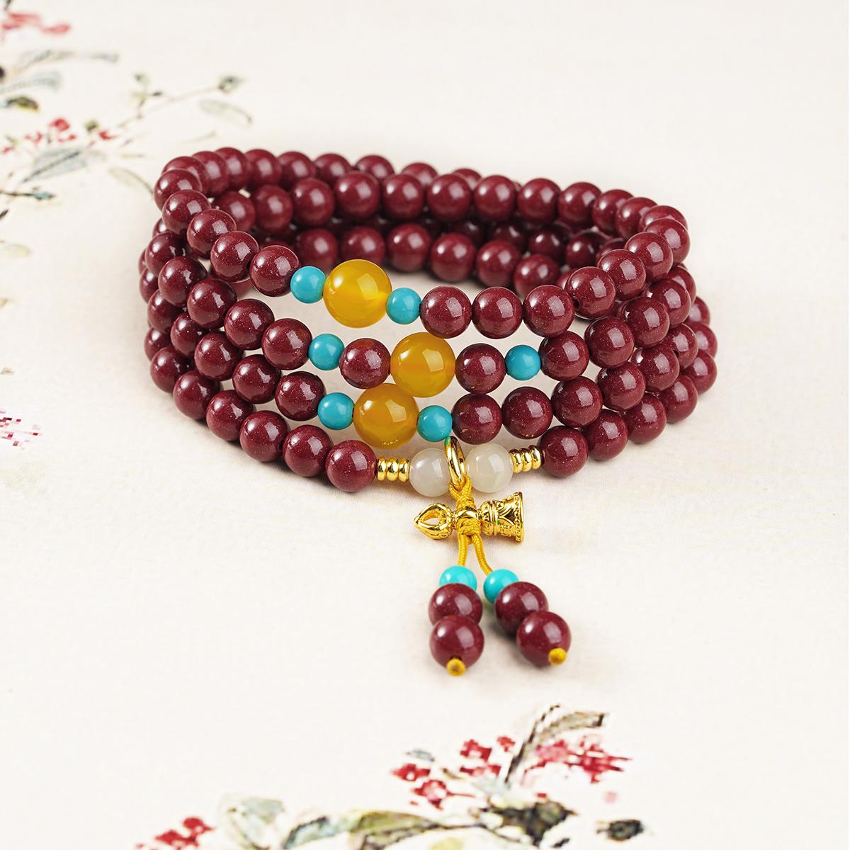 Cinnabar Tibetan mala necklace featuring 108 beads with agate, jade and glass elements, handcrafted spiritual jewelry.