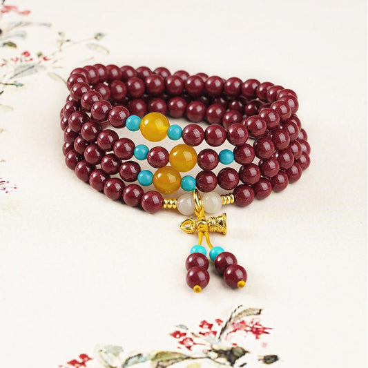 Cinnabar Tibetan mala necklace featuring 108 beads with agate, jade and glass elements, handcrafted spiritual jewelry.