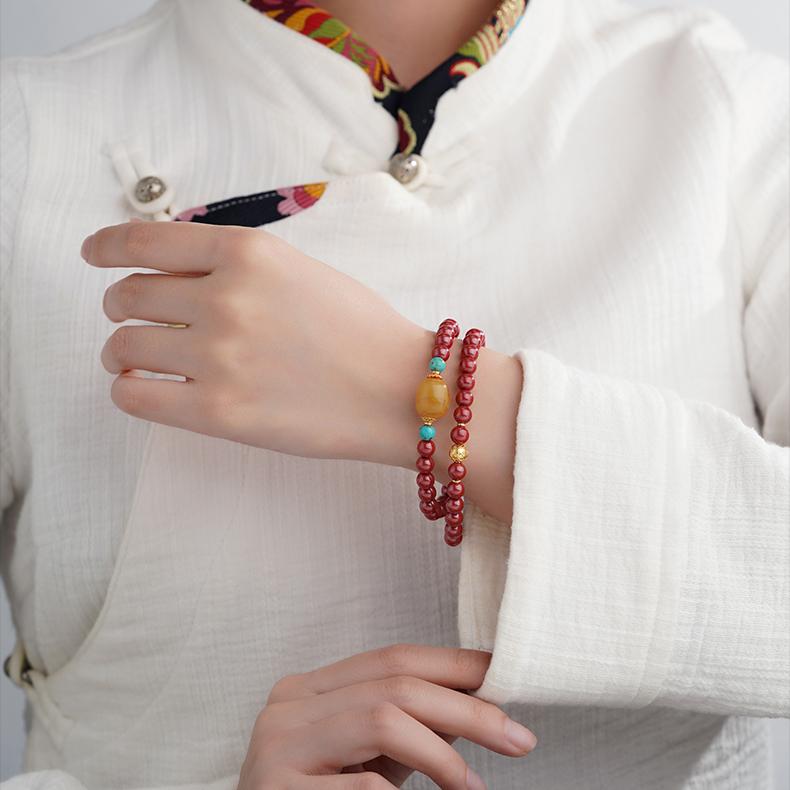 Multi ring cinnabar bracelet with amber and turquoise in Tibetan Buddhist jewelry style