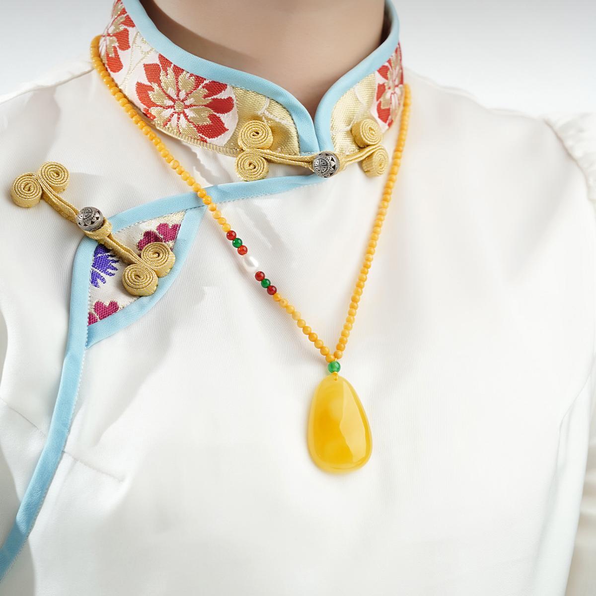 Artisan amber and agate necklace symbolizing energy flow, abundance, and well-being.