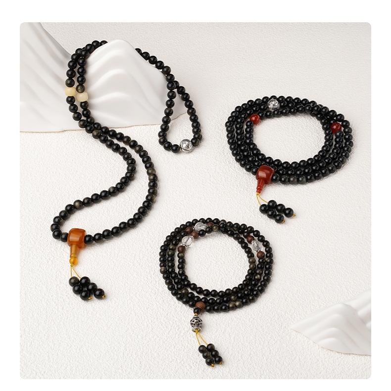 Spiritual Tibetan mala crafted from rainbow obsidian with silver elephant-head amulet.