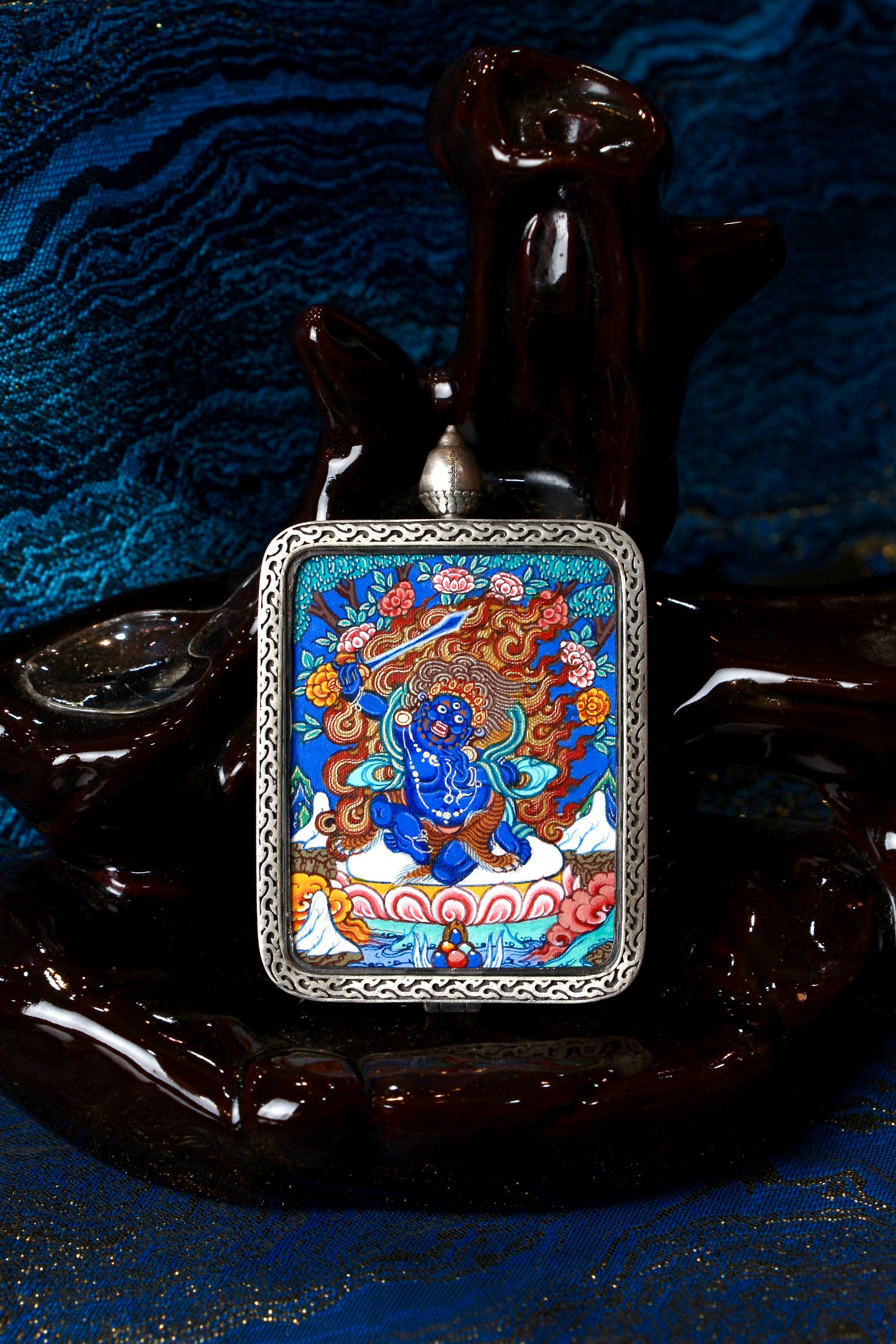 A sacred hand-painted Acala (Fudo Myoo) Thangka pendant from Regong, featuring the wrathful Wisdom King in a fine silver frame.