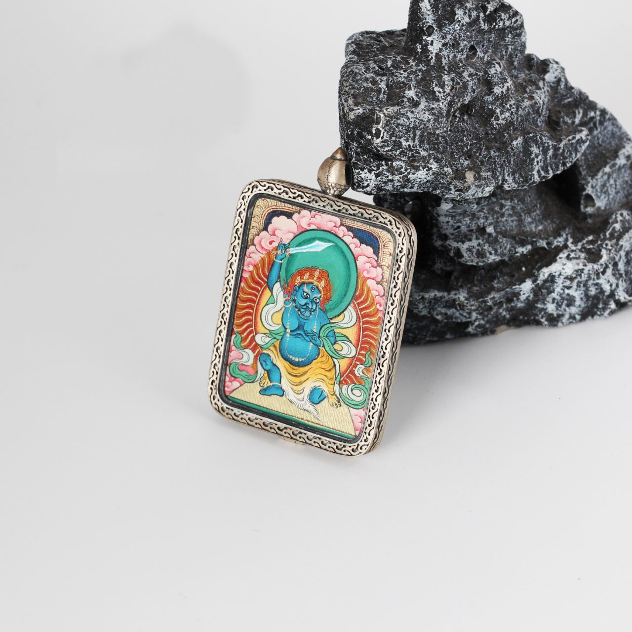  The Karma Kagyu Acala Thangka pendant displayed as a sacred amulet for protection and subjugation of obstacles, embodying Tibetan Buddhist tradition.
