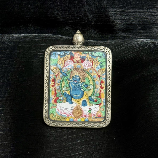 A 4x5cm hand-painted Menri-style Acala (Immovable One) Thangka pendant featuring the king of the wisdom kings, encased in 925 silver with Dunhuang Nine-Colour Deer design, symbolising discipline and obstacle removal in Tibetan Buddhist tradition.
