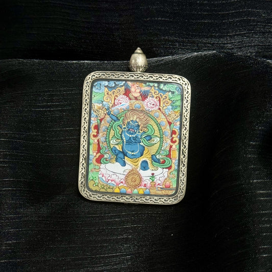  Close-up detail of the Menri Acala Thangka painting showing intricate natural mineral pigment work and symbolic attributes, showcasing the artistry of Tibetan lineage painters.
