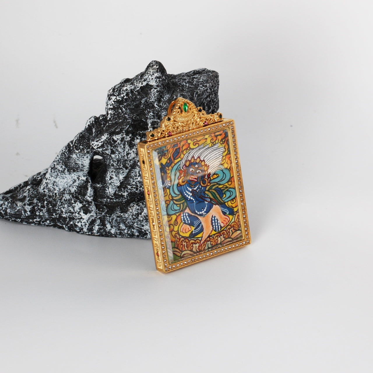 The Nepal Elegant Acala Thangka pendant displayed as a sacred amulet for protection and subjugation of obstacles, embodying Tibetan Buddhist tradition.

