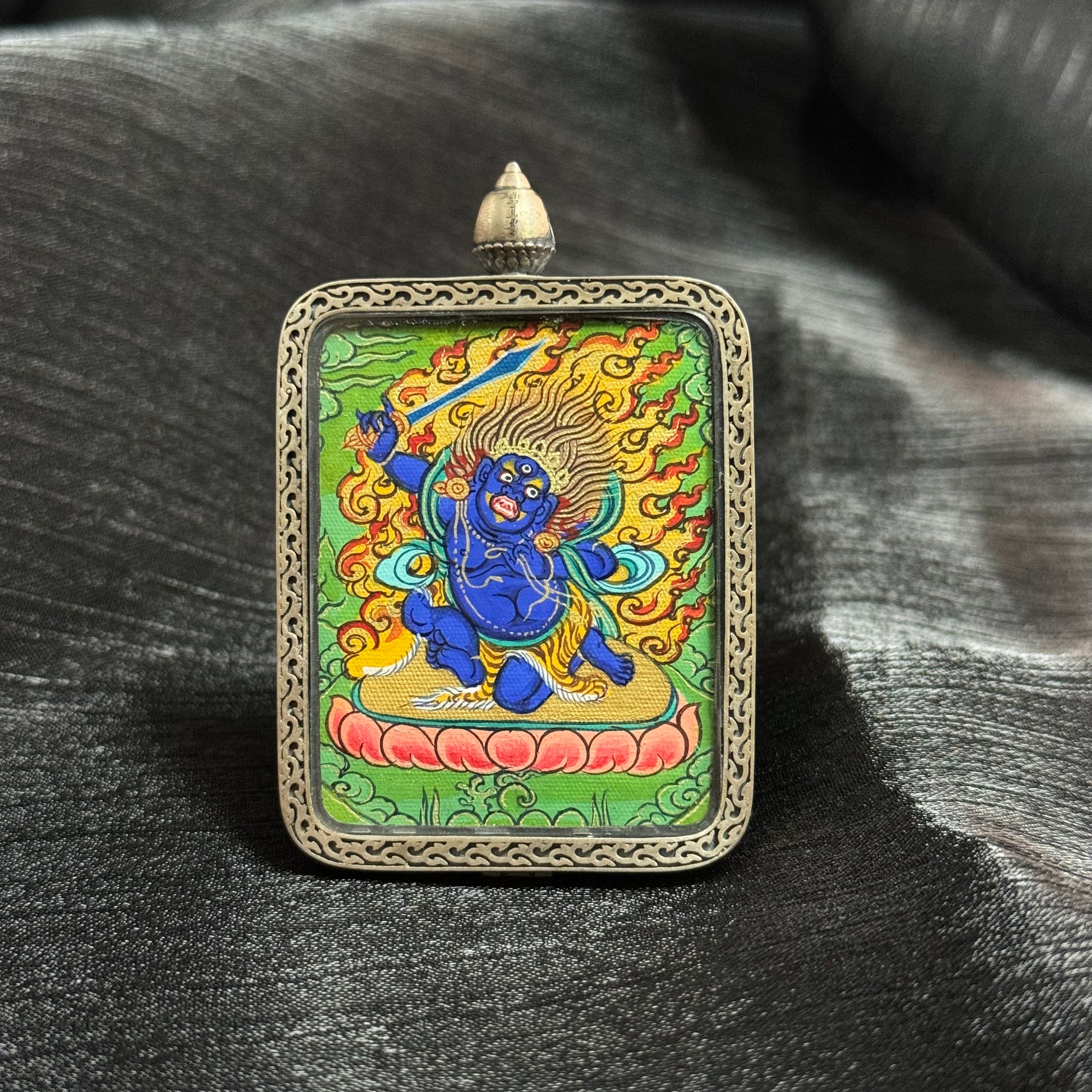 Detailed view of the presentation and casing for the Acala Cuiying Thangka pendant, symbolising protection and tradition in Buddhist practice.


