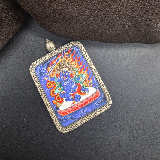  A 3.5x4.5cm hand-painted Rekong Blue Thangka Acala (不动明王) Thangka pendant with 925 silver featuring the Immovable One and chief of the five wisdom kings, representing discipline and protection in Buddhist tradition.
