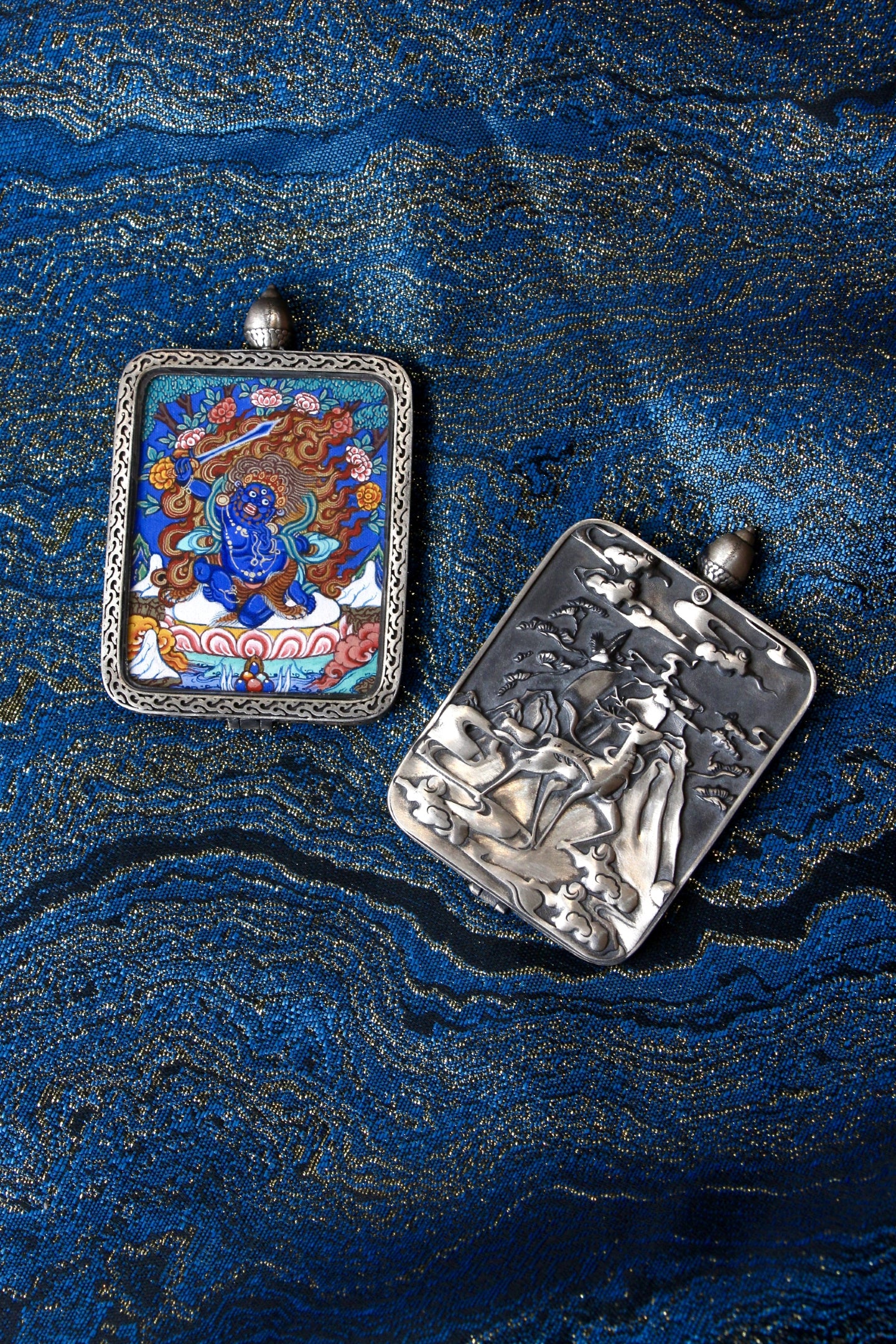 Close-up of the S925 sterling silver case with Dunhuang Nine-Colored Deer engraving, protecting the wrathful Acala Thangka.