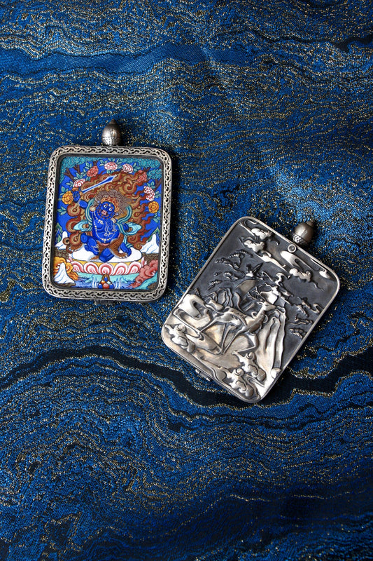 Close-up of the S925 sterling silver case with Dunhuang Nine-Colored Deer engraving, protecting the wrathful Acala Thangka.