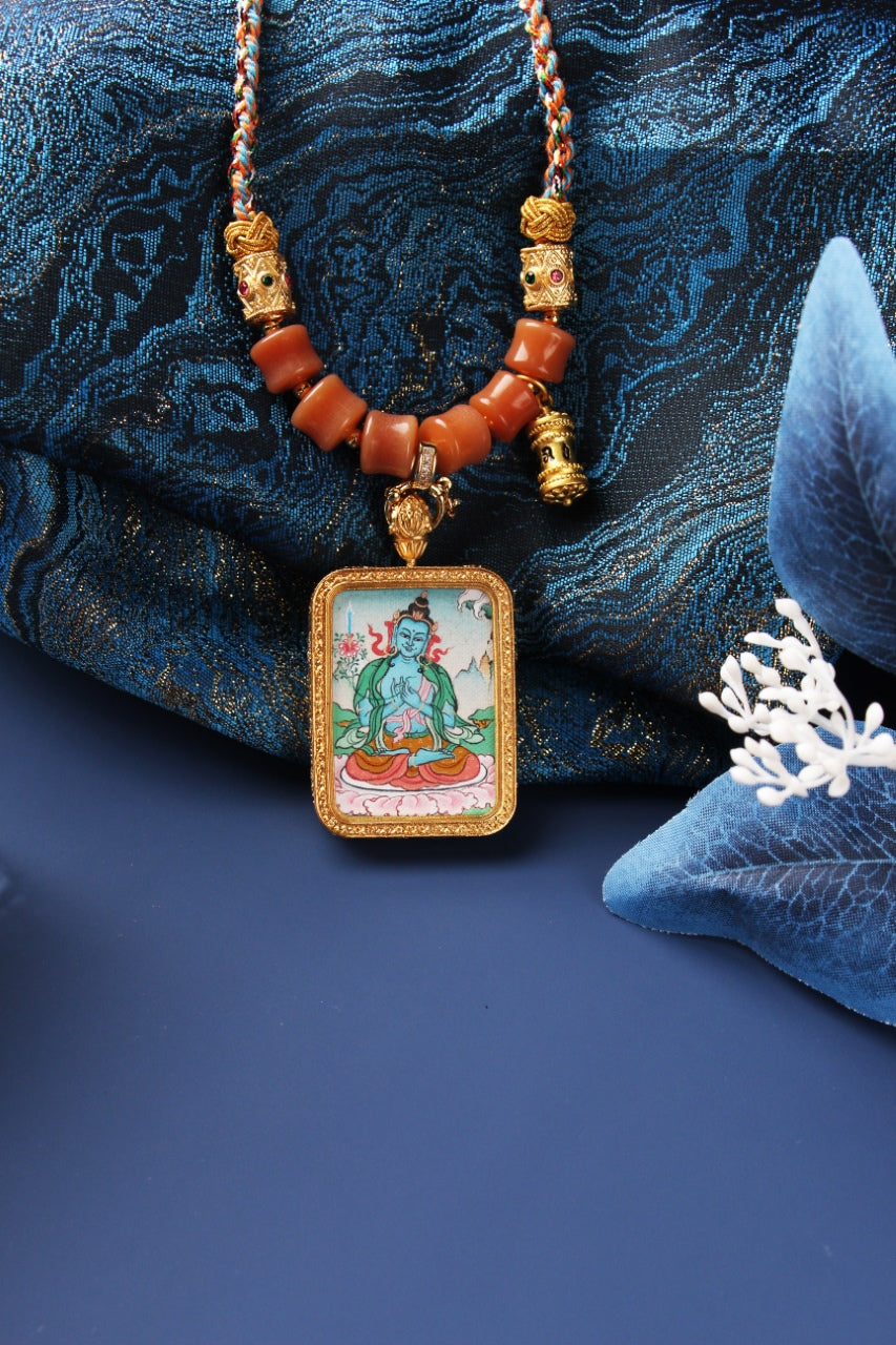  A 2.5x3.5cm hand-painted Karma Kagyu Akasagarbha Bodhisattva Thangka pendant featuring the Bodhisattva of the Treasury of Space, encased in titanium steel, representing wealth and merit in Tibetan Buddhist tradition.
