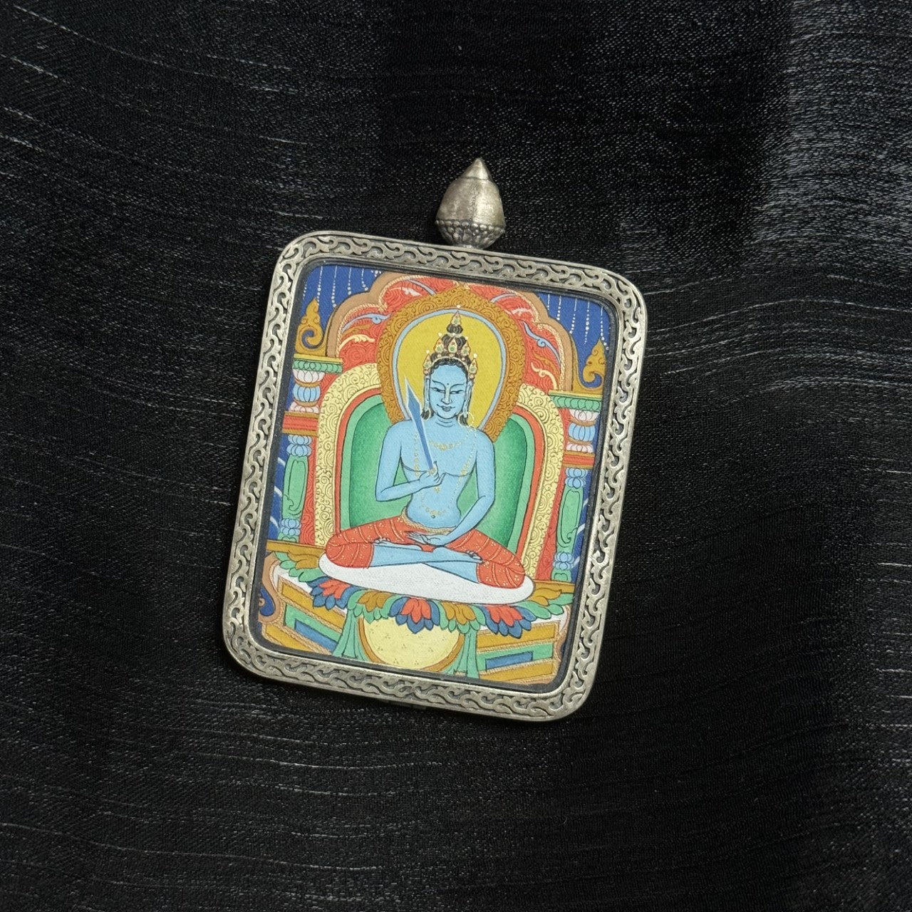  A 4x5cm hand-painted Karma Kagyu Akasagarbha Bodhisattva Thangka pendant featuring the Bodhisattva of the Treasury of Space, encased in 925 silver Dunhuang Nine-Colour Deer casing, representing wealth and merit in Tibetan Buddhist tradition.
