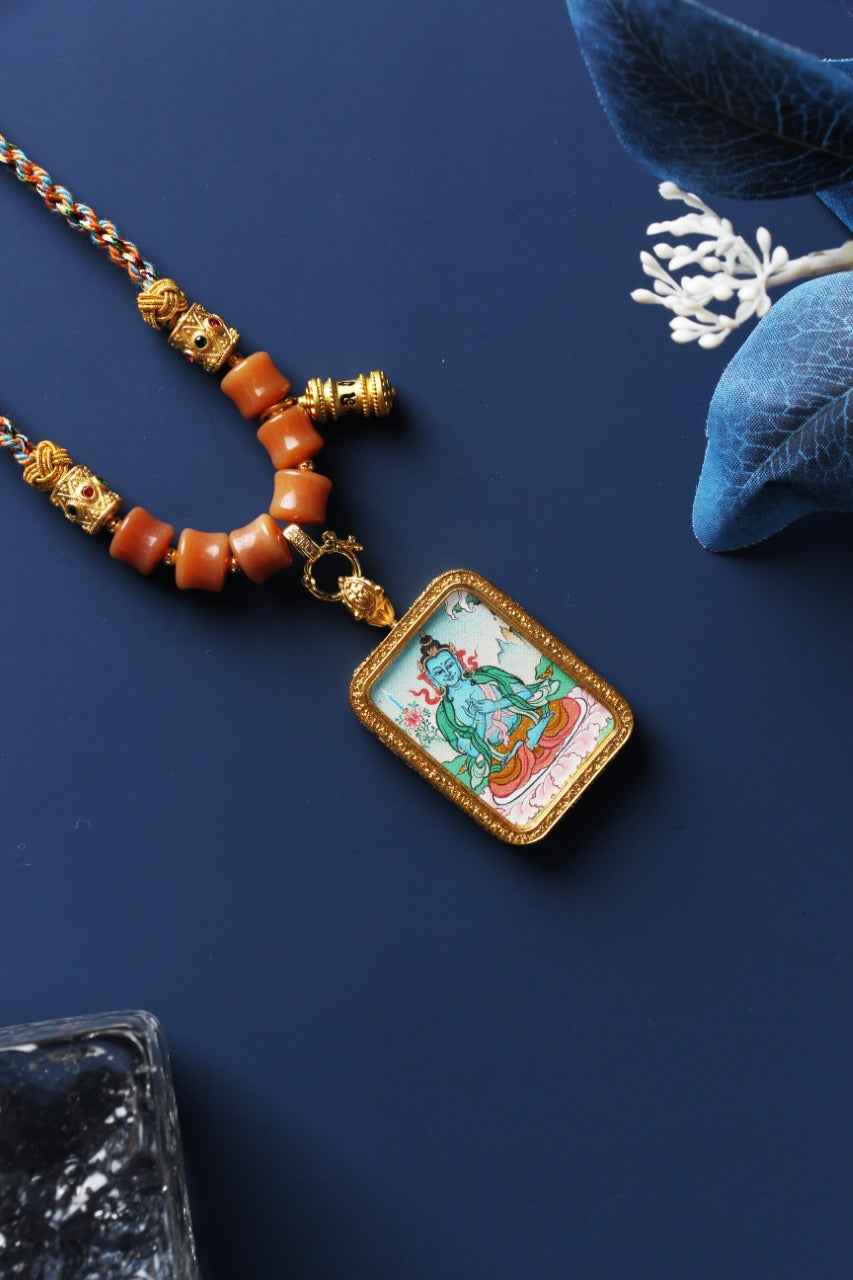 Close-up detail of the Karma Kagyu Akasagarbha Thangka painting showing intricate natural mineral pigment work and jewel symbolism, showcasing the masterful artistry of Tibetan lineage painters.

