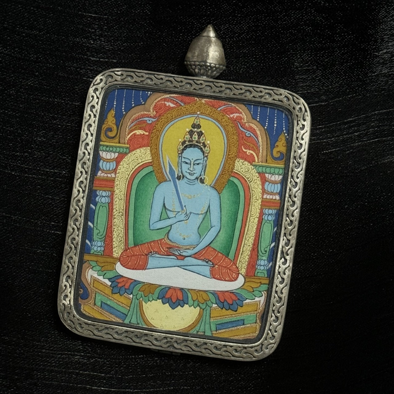  The Karma Kagyu Akasagarbha Thangka pendant displayed as a sacred amulet for wealth and prosperity, embodying the space treasury wisdom of Tibetan Buddhist tradition.
