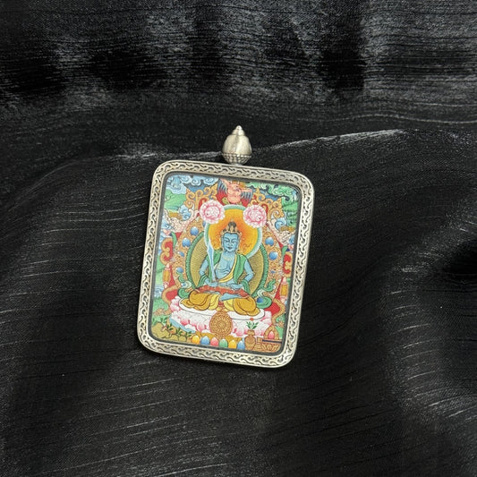  A 4x5cm hand-painted Menri-style Akasagarbha Bodhisattva Thangka pendant featuring the Treasury of the Void, encased in 925 silver with Dunhuang Nine-Colour Deer design, symbolising wealth and noble support in Tibetan Buddhist tradition.
