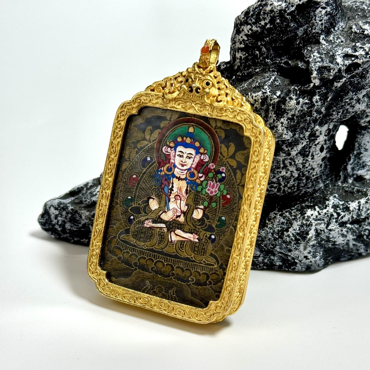 The Nepal Black Gold Akasagarbha Thangka pendant displayed as a sacred amulet for wealth and merit, embodying Tibetan Buddhist tradition.
