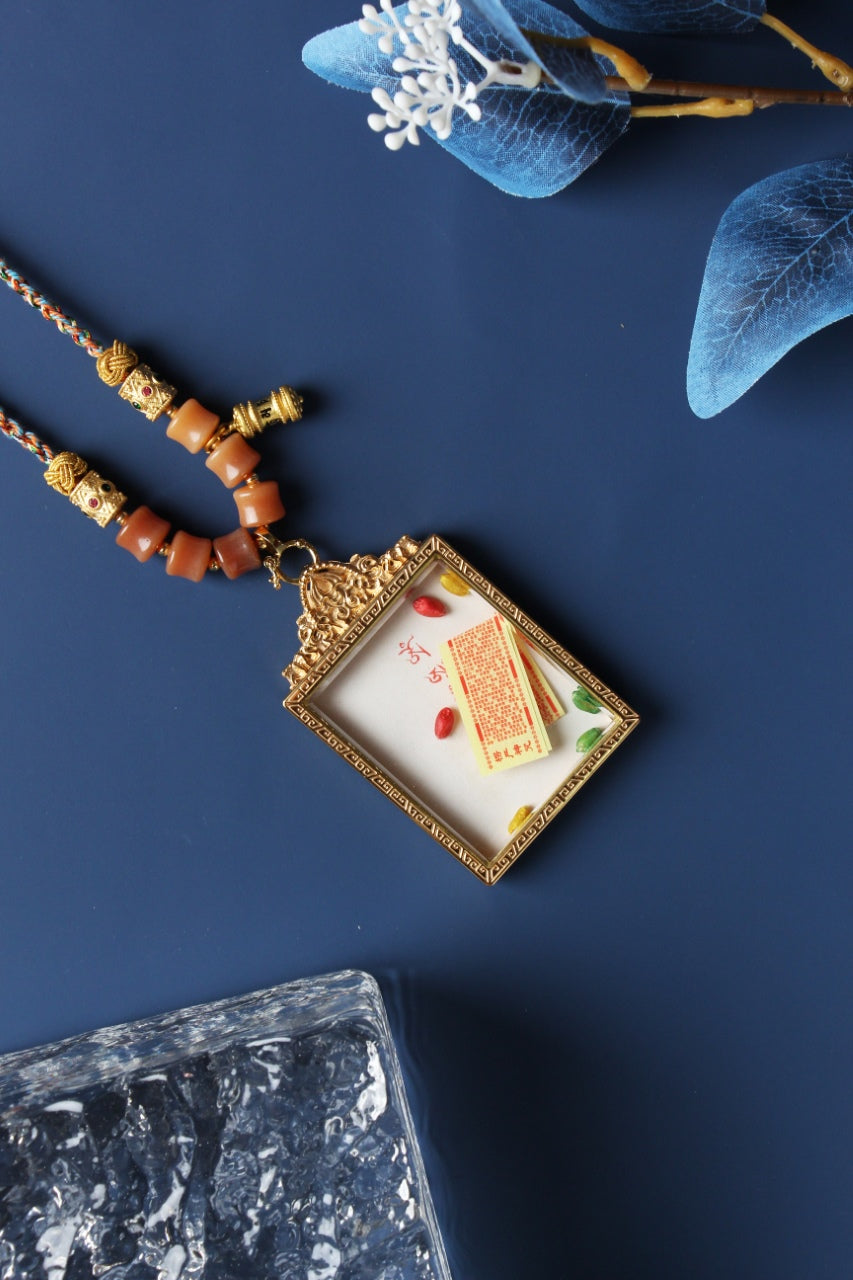 A 4x5cm hand-painted Rebgong Akasagarbha Bodhisattva Thangka pendant featuring the Bodhisattva of the Treasury of Space, encased in titanium steel, representing wealth and merit in Tibetan Buddhist tradition.
