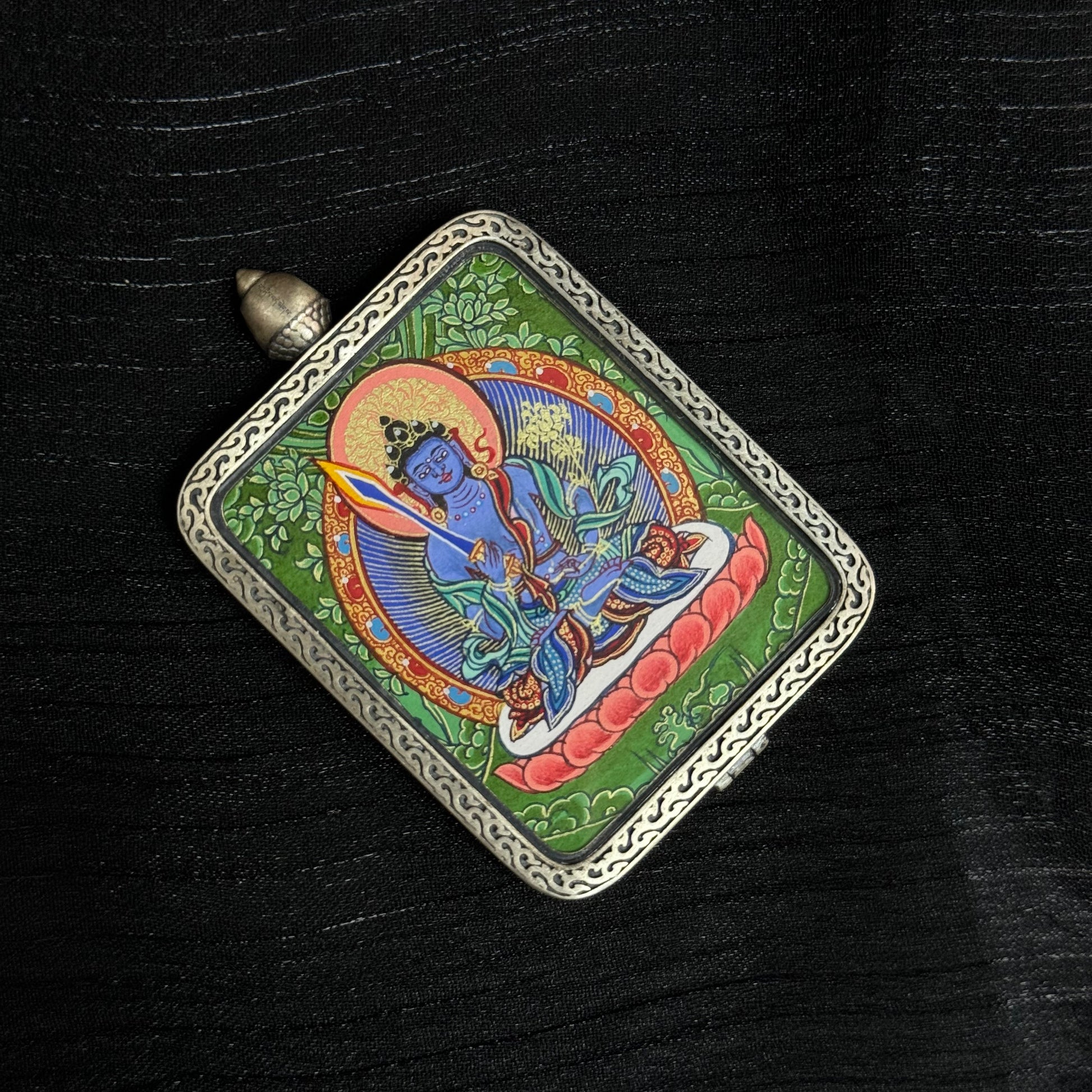  The Rekong Cuiying Akasagarbha Thangka pendant displayed as a sacred amulet for wealth and protection, embodying Buddhist tradition.
