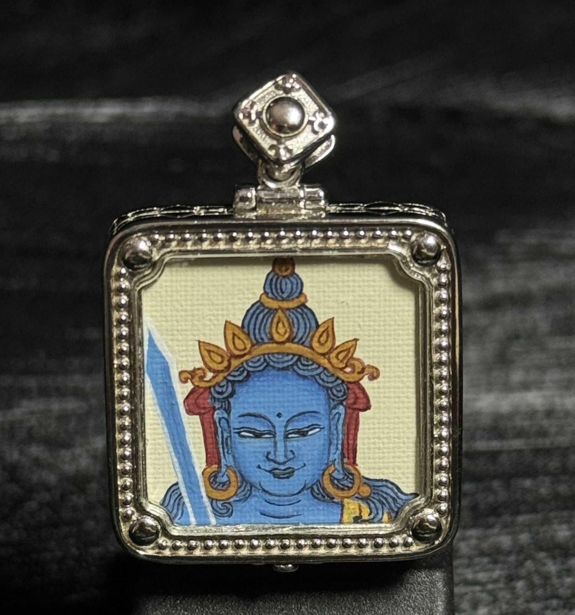  Close-up detail of the Tibet Akasagarbha Thangka painting showing natural mineral pigments, showcasing the masterful artistry of Tibetan lineage painters.
