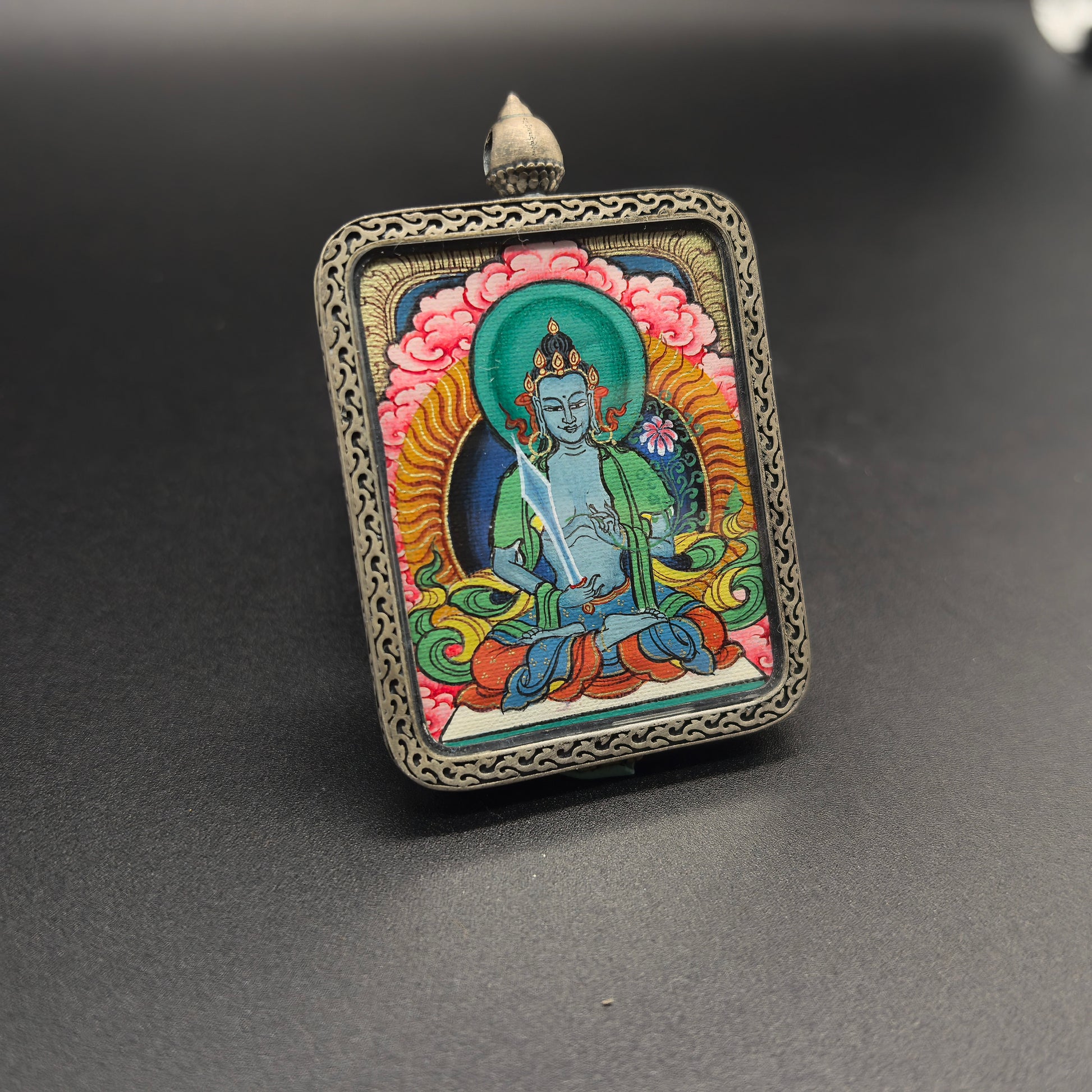 A 3.5x4.5cm hand-painted Tibet Red Cloud Akasagarbha (虚空藏菩萨) Thangka pendant with 925 silver featuring the wealth deity of the Buddhist realm, representing wealth and fortune in Buddhist tradition.

