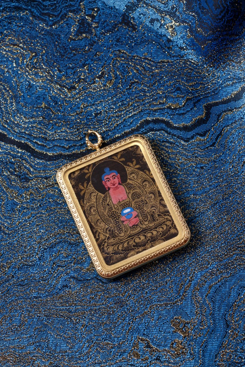 Amitabha Buddha thangka pendant depicting the Buddha of Infinite Light and compassion in Tibetan Buddhist culture.