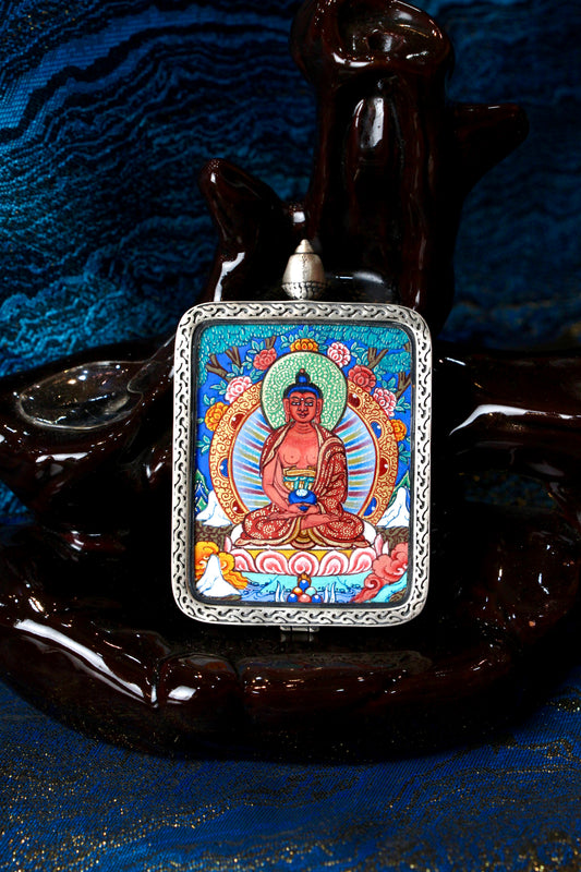 A sacred hand-painted Amitabha Buddha Thangka pendant from Regong, featuring the Buddha of Infinite Light in a fine silver frame.