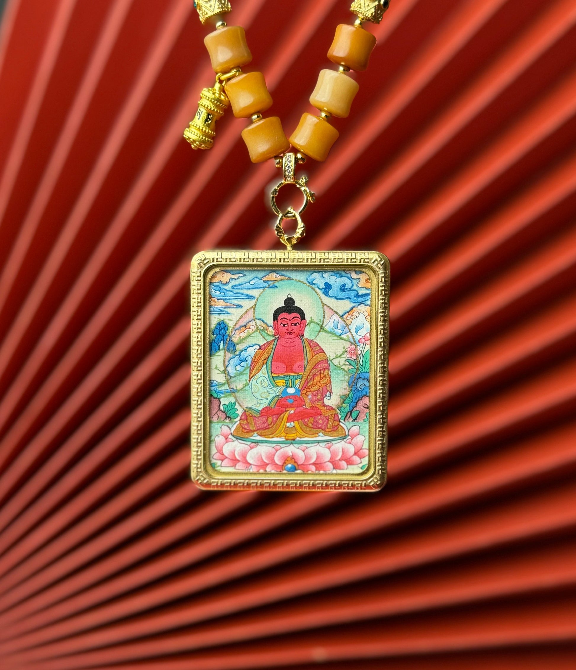  Detailed view of the titanium casing for the Amitabha Thangka pendant, symbolising peace and tradition in Buddhist practice.

